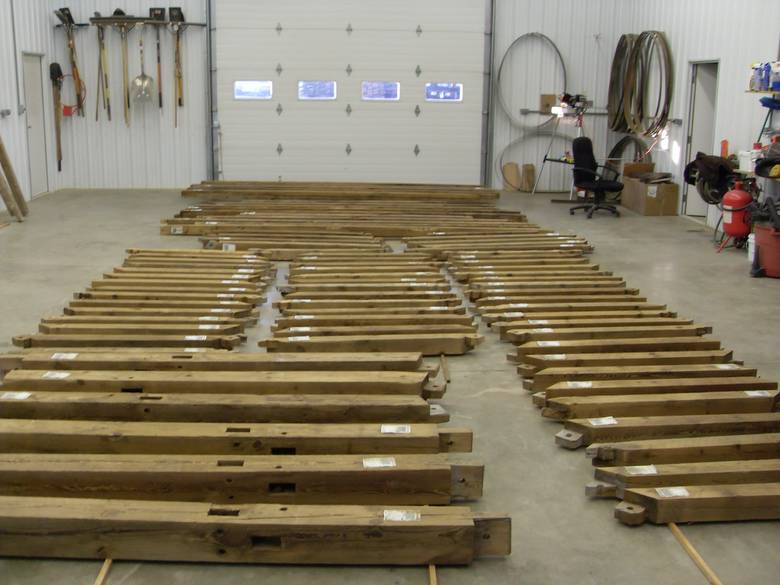 Camp Barn Restoration / Cannon Salvage workers cleaning, applying borate, and waxing the frame.